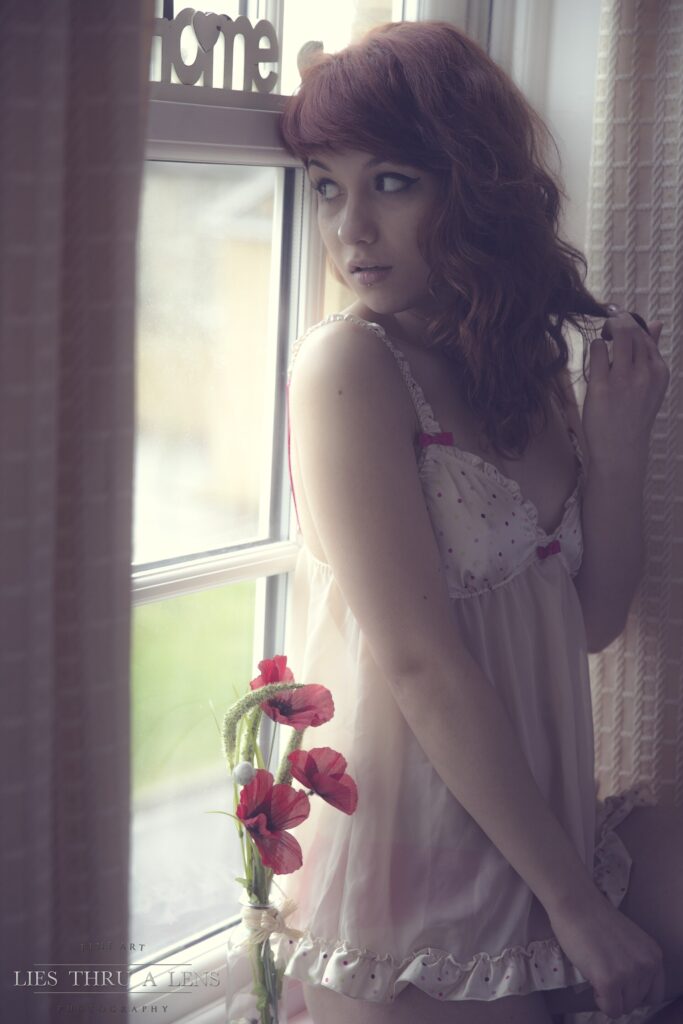 A person gazing out of a window, lost in thought